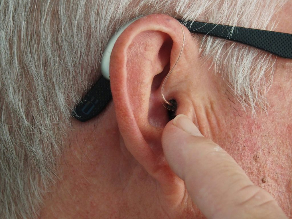 hearing aid senior ear closeup